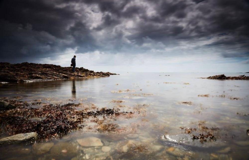 Figure beside the sea