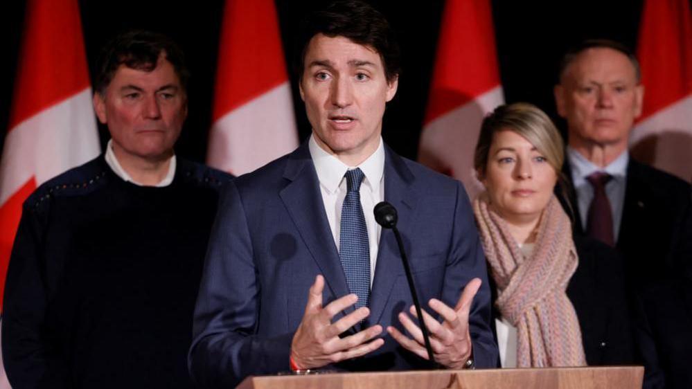 Canada's Prime Minister Justin Trudeau, with Finance Minister Dominic LeBlanc, Minister of Foreign Affairs Melanie Joly, and Minister of Public Safety David McGuinty, takes part in a press conference during a Liberal Cabinet Retreat in Montebello, Quebec, Canada January 21, 2025.