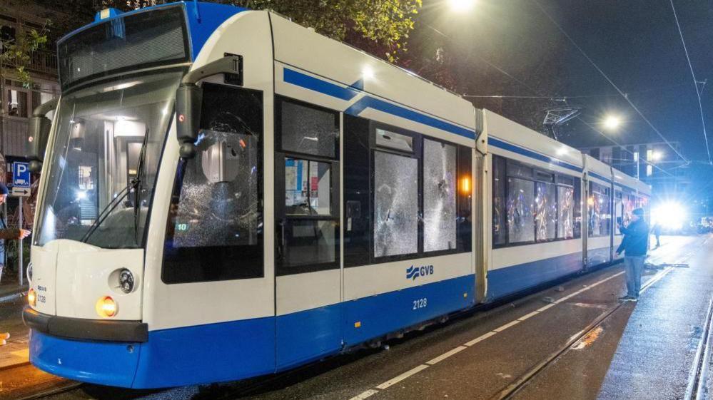 The windows of a tram are seen shattered after riots in Amsterdam, Netherlands, November 11, 2024. 