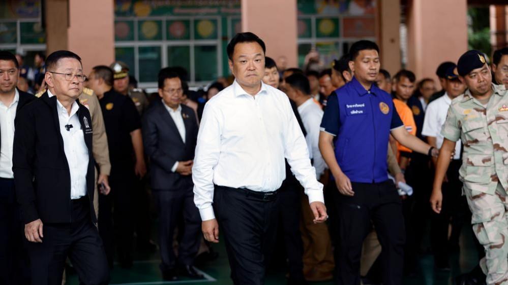 Thai Prime Minister Anutin Charnvirakul, wearing a white, visits the school