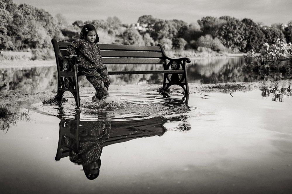 Child playing in puddle