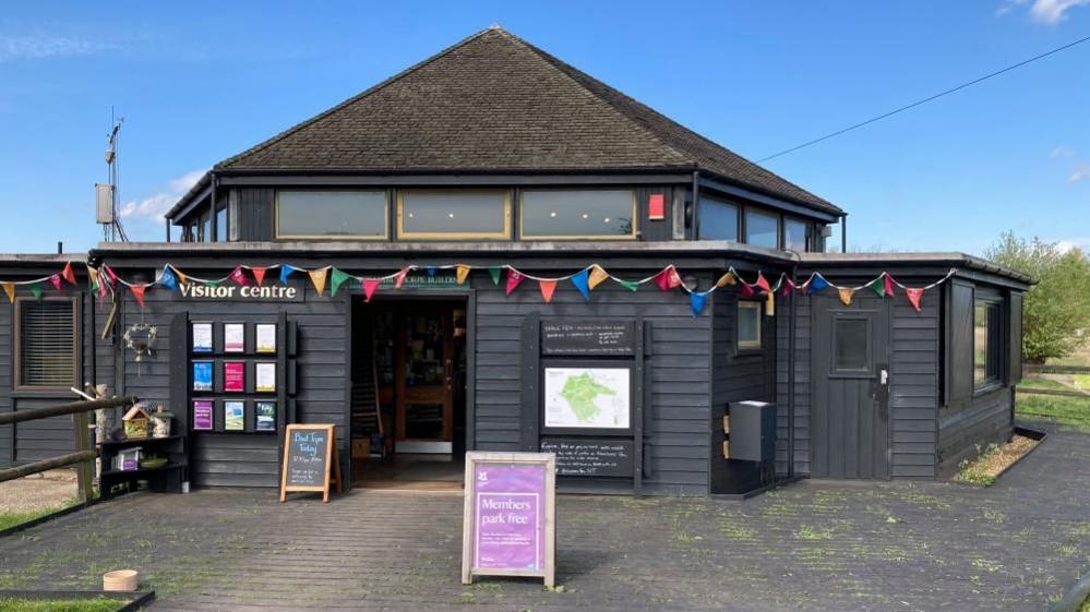 Wicken fen visitor centre with sign saying 'members park free'