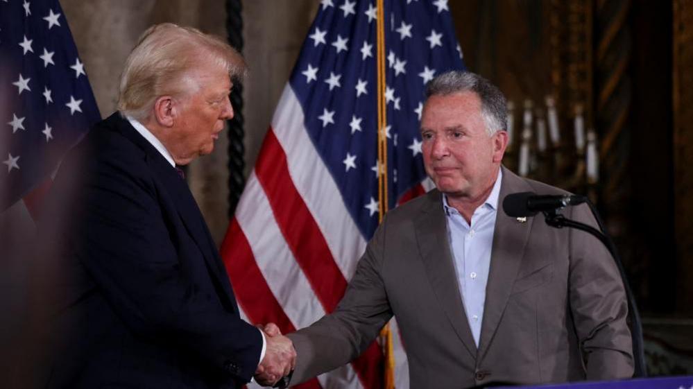 Donald Trump and Steve Witkoff shaking hands on stage