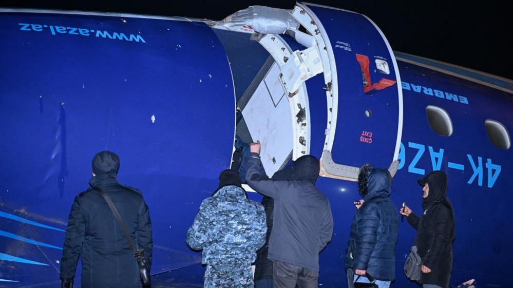 The wreckage of a blue Azerbaijan Airlines plane that crashed in Kazakhstan