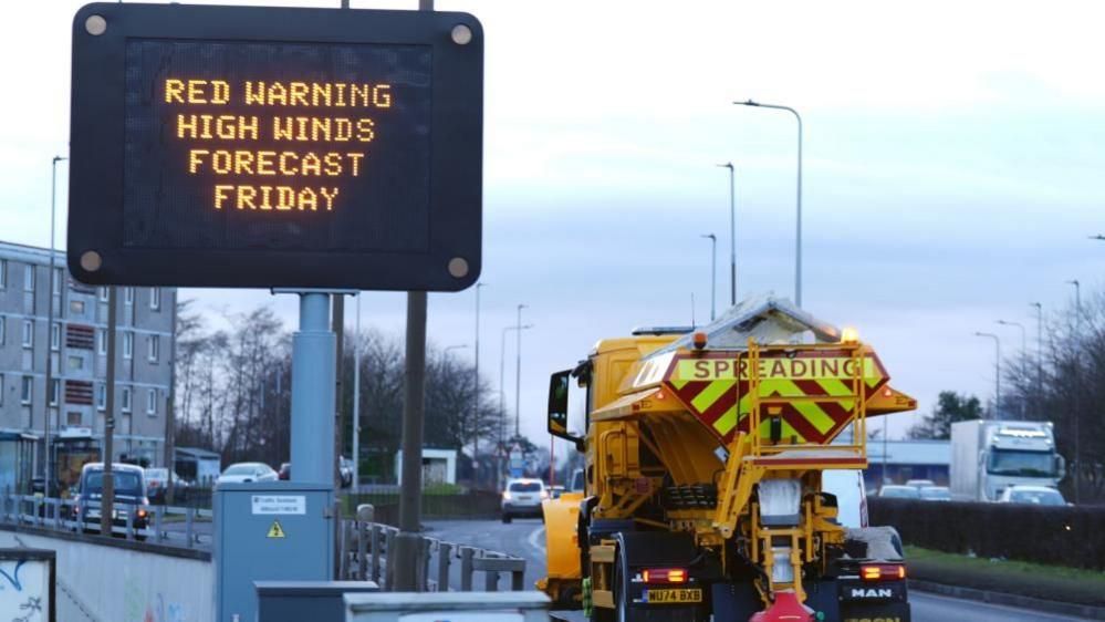 A road sign displaying a red weather warning for Friday on Calder Road, Edinburgh