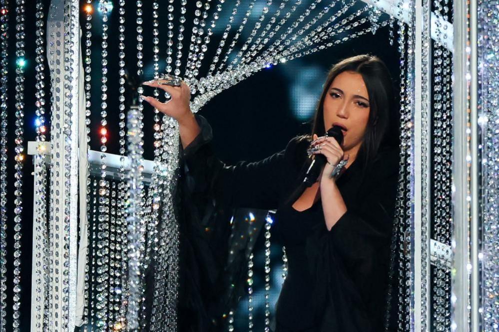 Israel's entry Yuval Raphael performs during rehearsals in a black dress surrounded by a detailed sparkled stage prop.