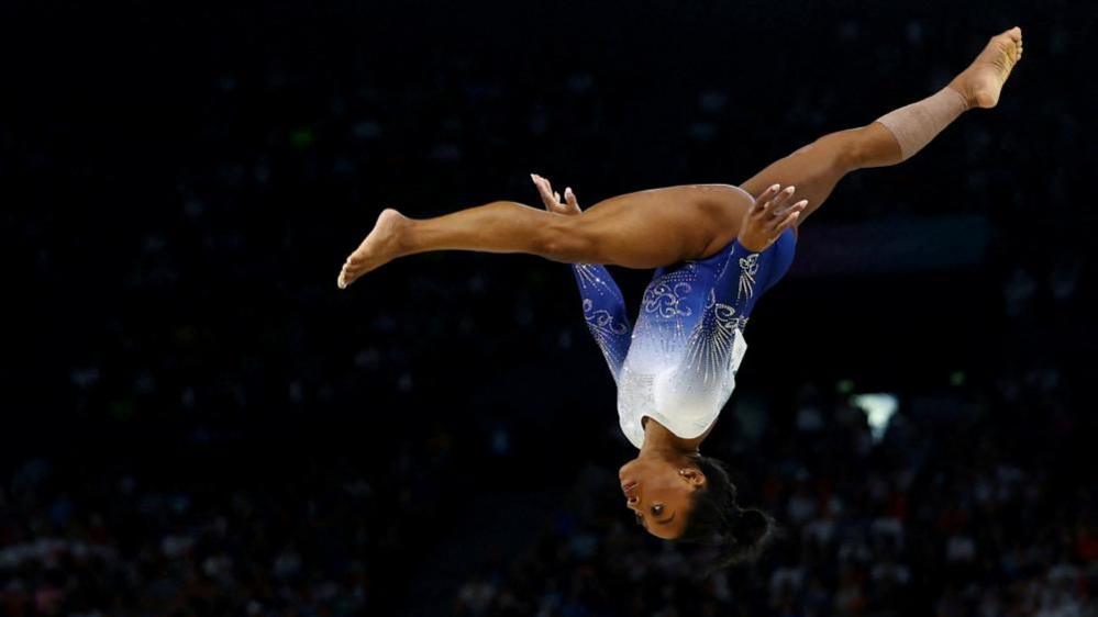 Simone Biles performs in a gymnastics event