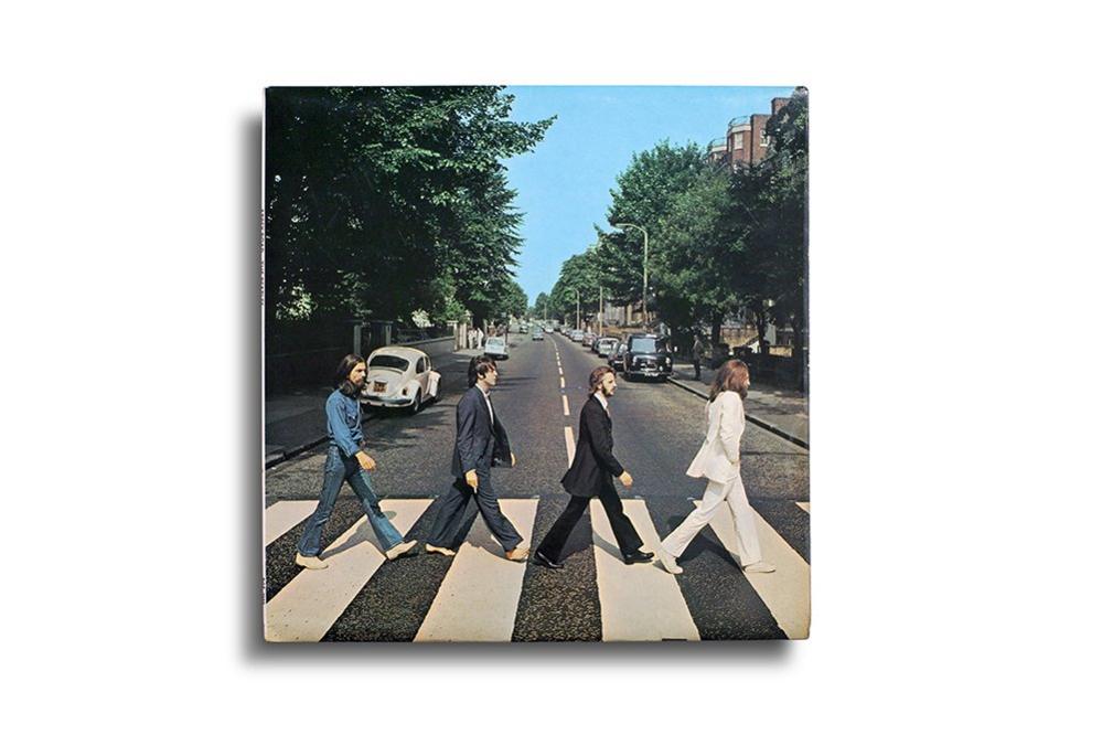 The Beatles walking across the zebra crossing of Abbey Road for their album cover