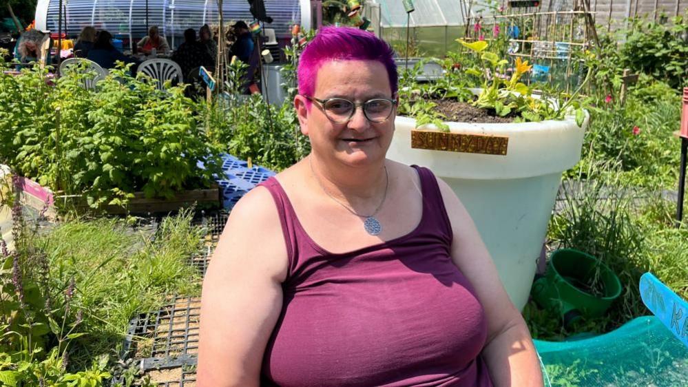 Photo of Lucie in front of the allotment