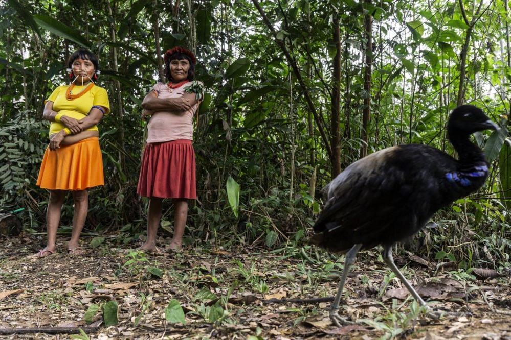 Two women pose for the camara in the Waikas community