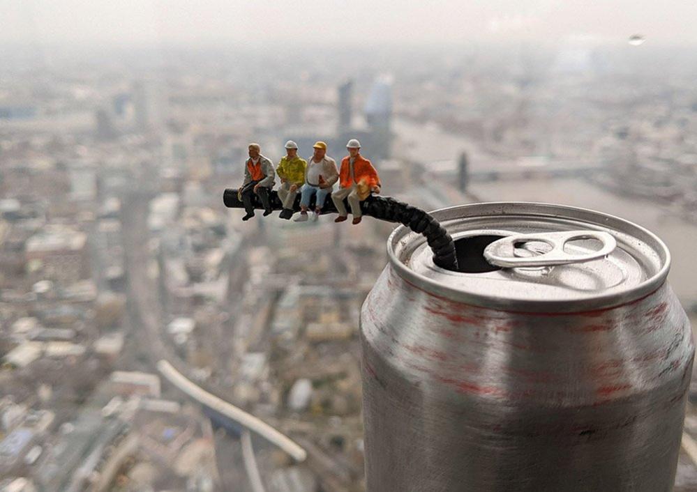 Model figures sit on a straw atop The Shard in London