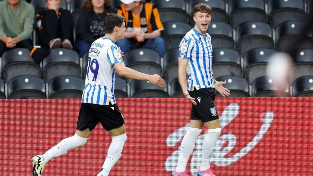 Charlie McNeill celebrates a goal with a team-mate