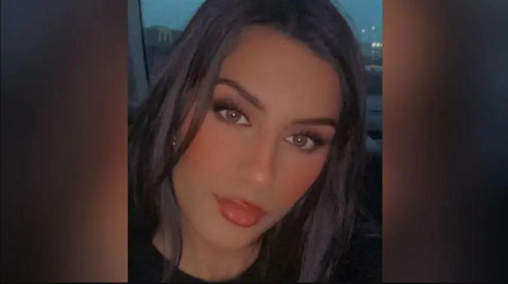 Madia Kauser, with long dark hair and hazel eyes, is photographed while sitting in a vehicle