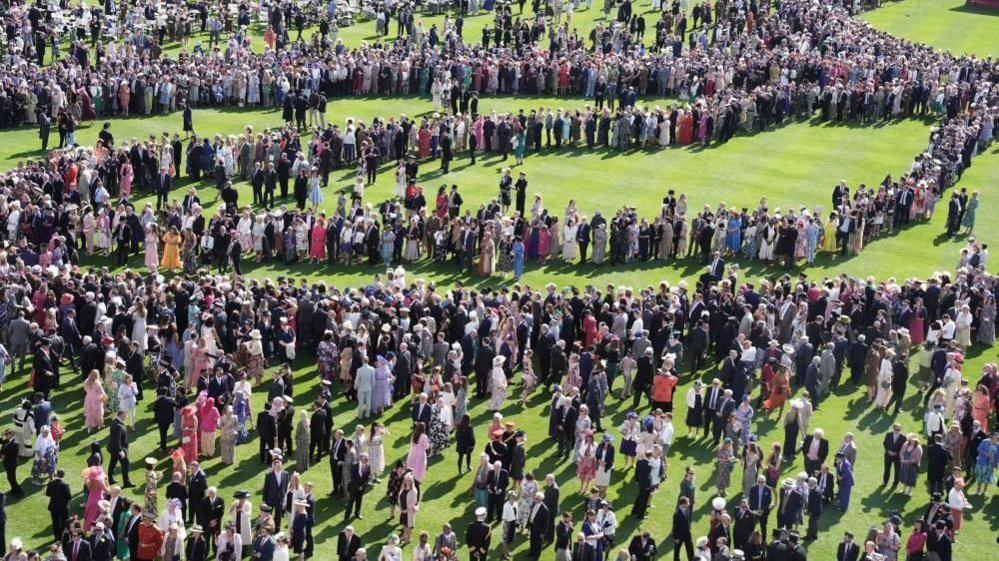 Crowds on the lawn at Buckingham Palace