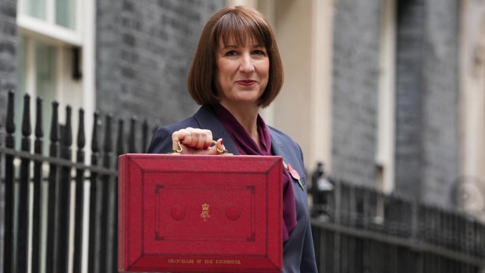 Rachel Reeves poses with the red budget box outside her office on Downing Street in London