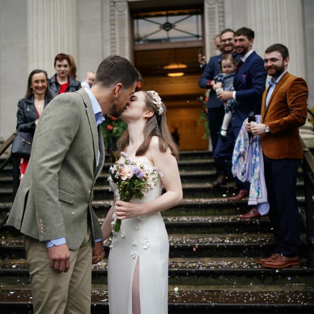 Newly married couple Christopher Hohls and Madeleine Crean, kiss on the steps of Old Marylebone Town Hall