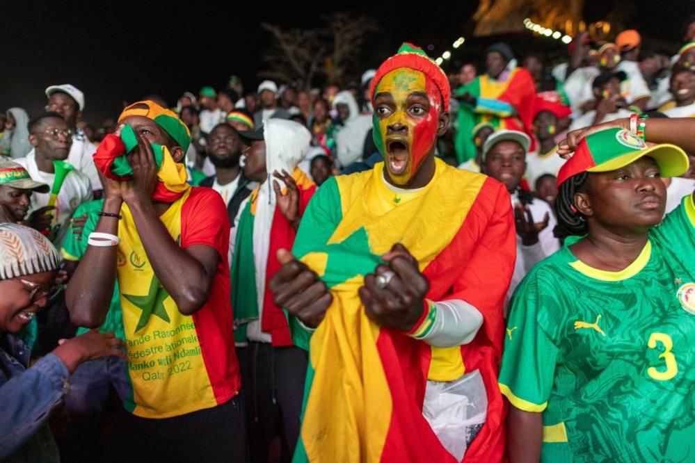 Senegalese soccer fans cheer as they watch the Africa Cup of Nations (AFCON) final match between Senegal and Morocco in Dakar