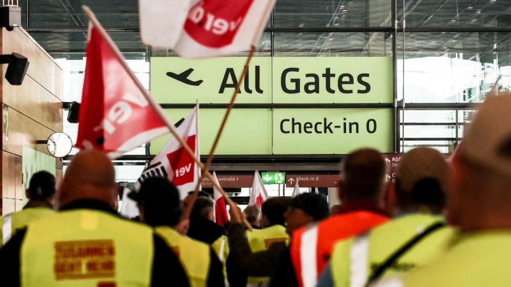 Airport workers protest at a terminal of the Berlin-Brandenburg airport, in Schönefeld, Germany, 10 March 2025