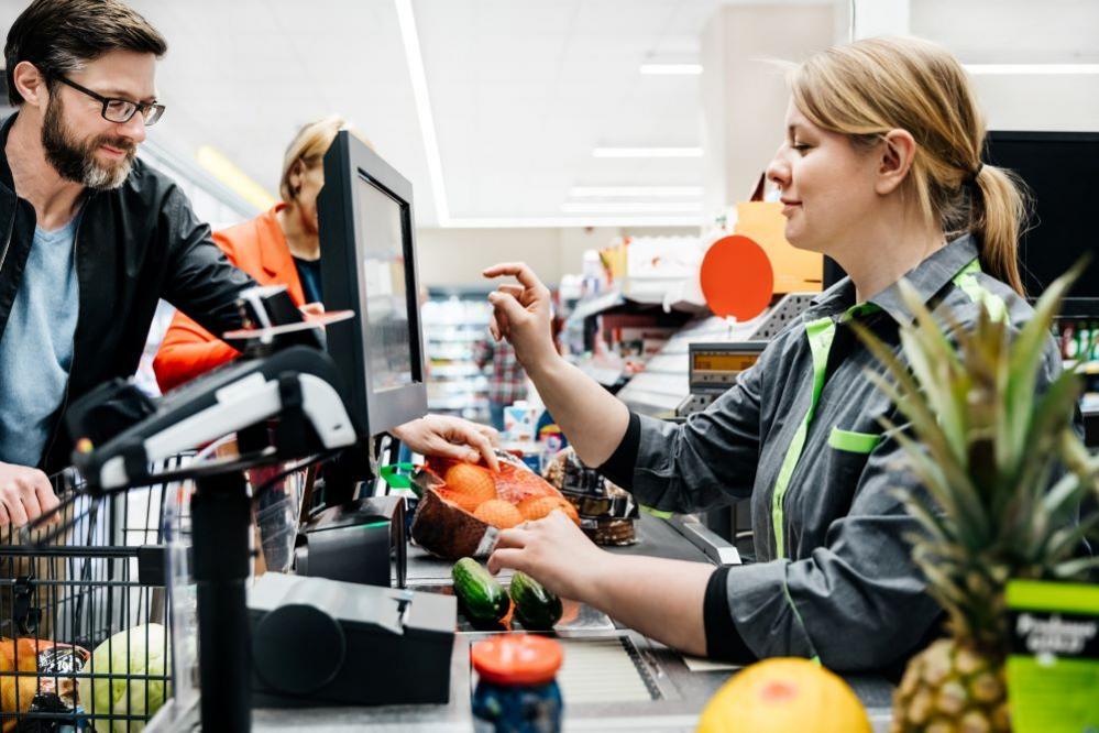 man at supermarket tills