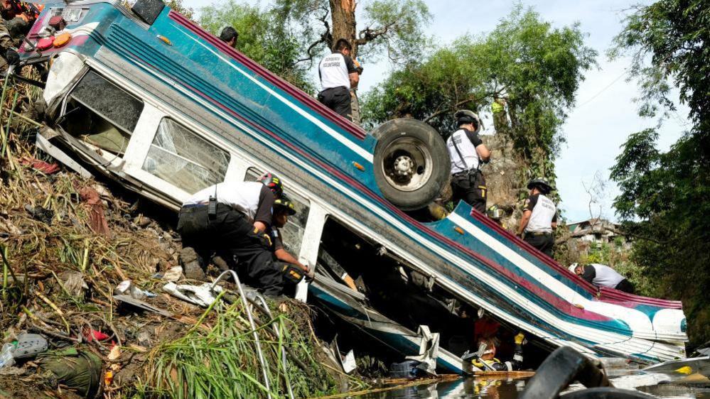 First responders work at the site of a deadly bus crash, in Guatemala City, 