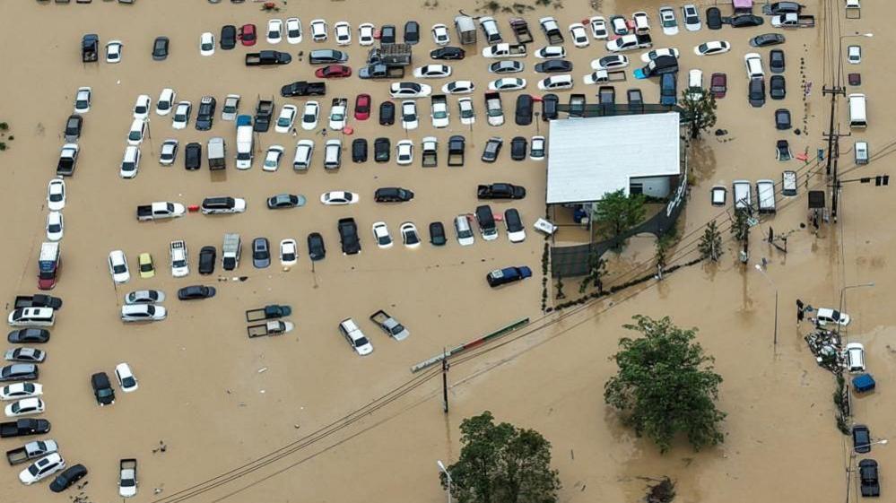A drone view shows cars parked in a flooded area in Hat Yai