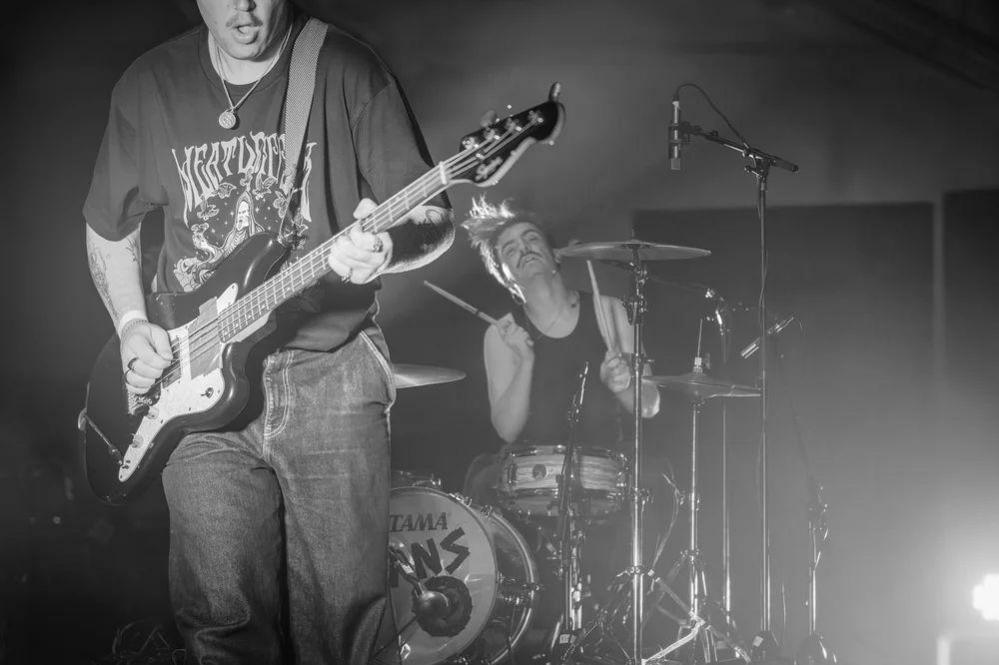 Gans guitarist and drummer are pictured in black and white at the Birmingham Town Hall gig.