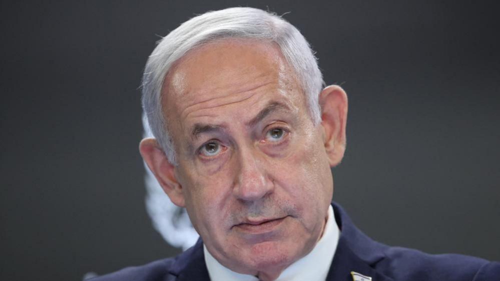 A file photo of Netanyahu - he is wearing a suit and looking up 