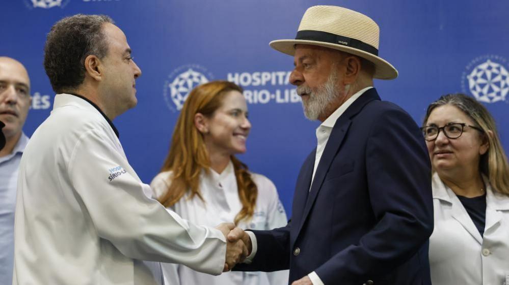 Brazil's President Luiz Inácio Lula da Silva shakes his doctor's hand. 