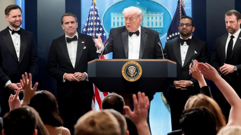 U.S. President Donald Trump speaks next to Federal Bureau of Investigation (FBI) Director Kash Patel, acting Attorney General Todd Blanche, Vice President JD Vance and Homeland Security Secretary Markwayne Mullin at a press briefing at the White House, following a shooting incident during the annual White House Correspondents’ Association dinner, in Washington, D.C.,