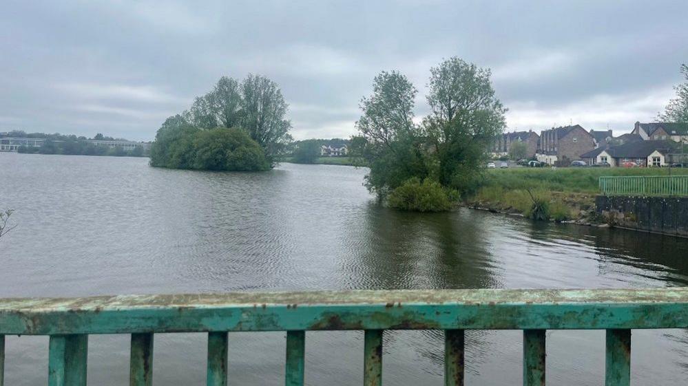 Lake with fence in foreground