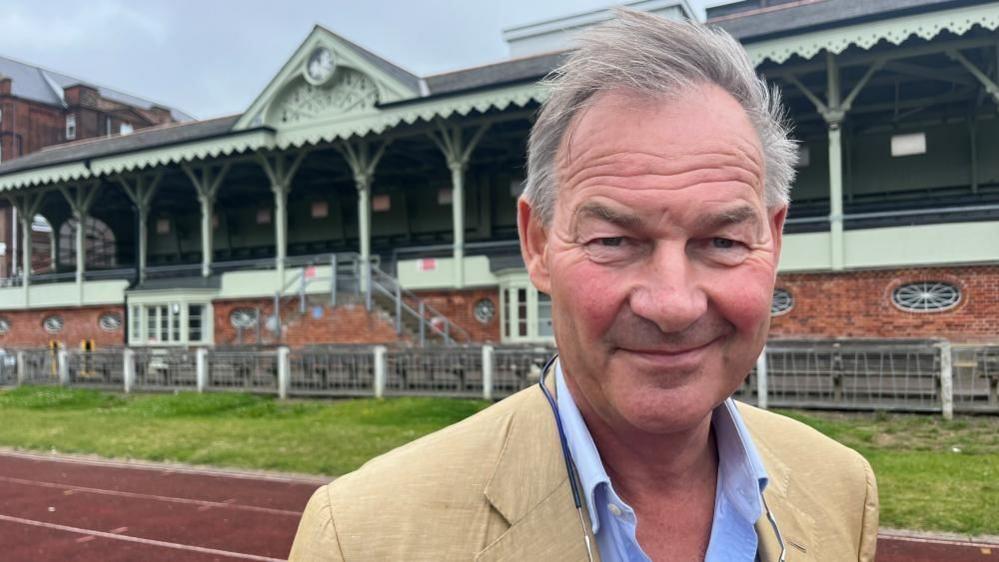 Rupert Lowe standing in front of the Wellesley Football Stand in Great Yarmouth