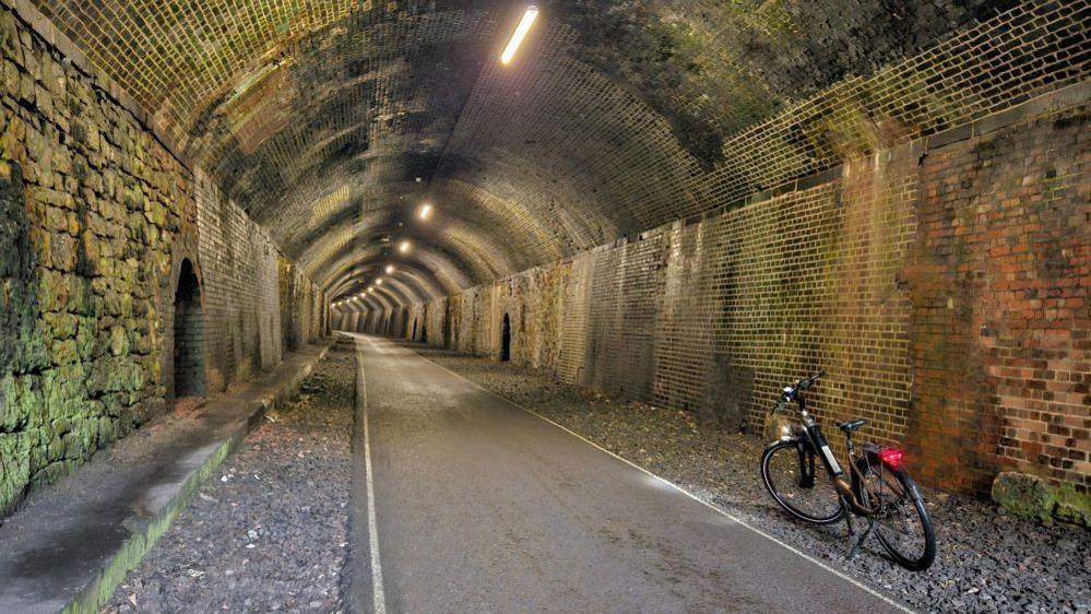 A bicycle in a long brick tunnel in the Peak District