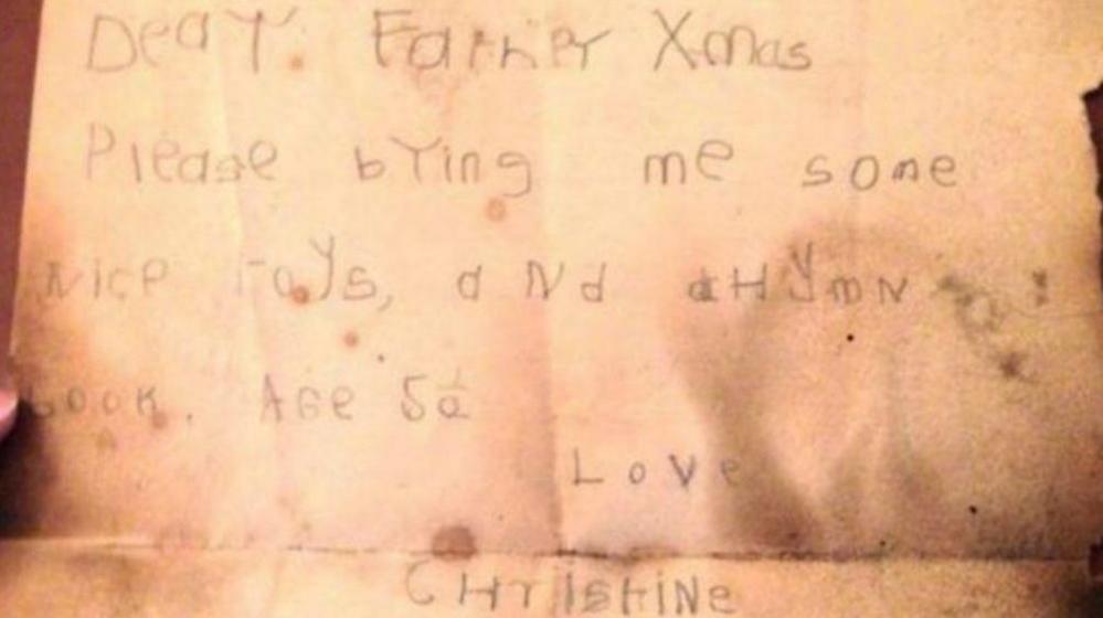 A sepia coloured letter with darker damp spots. It is addressed to Father Xmas and is carefully written by Christine, who says she is aged 5