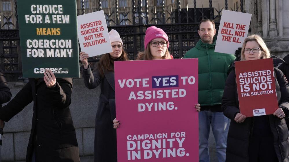 Proponents and opponents of the Terminally Ill Adults (End of Life) Bill demonstrate outside Westminster, London's Houses of Parliament.