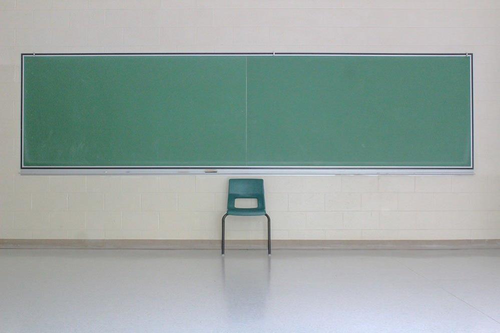 Empty classroom blackboard and chair