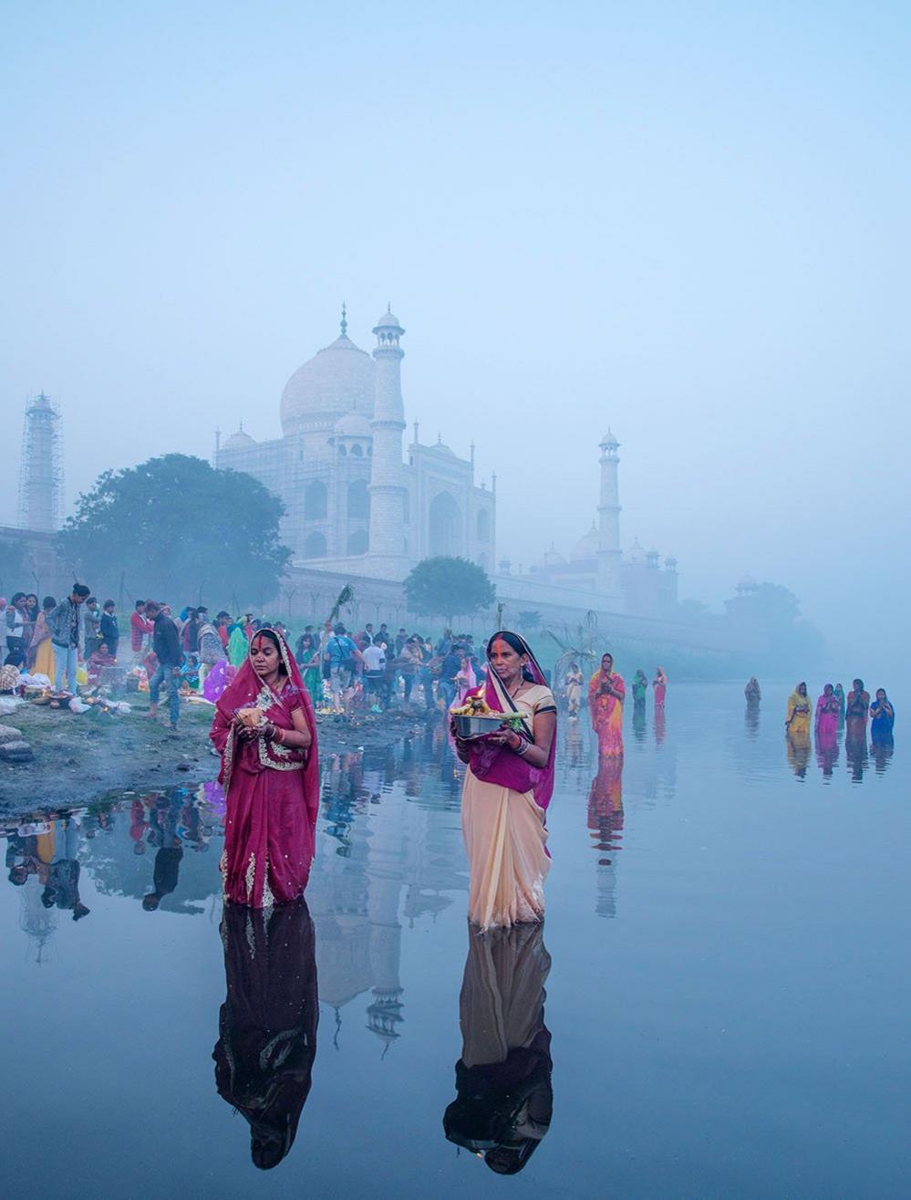 Women pray in a river