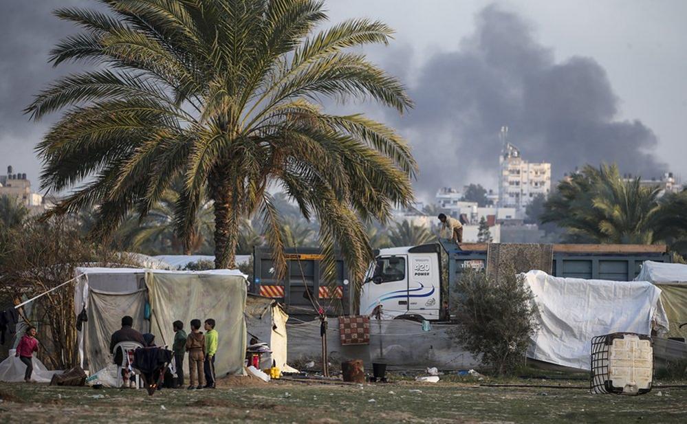 Palestinian children who fled with their families from the northern Gaza Strip, play around their families shelters, in the west of Deir Al Balah town southern Gaza Strip, 10 January 2024