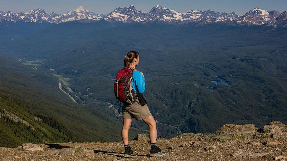 A woman looking at the Rocky Mountains in Canada