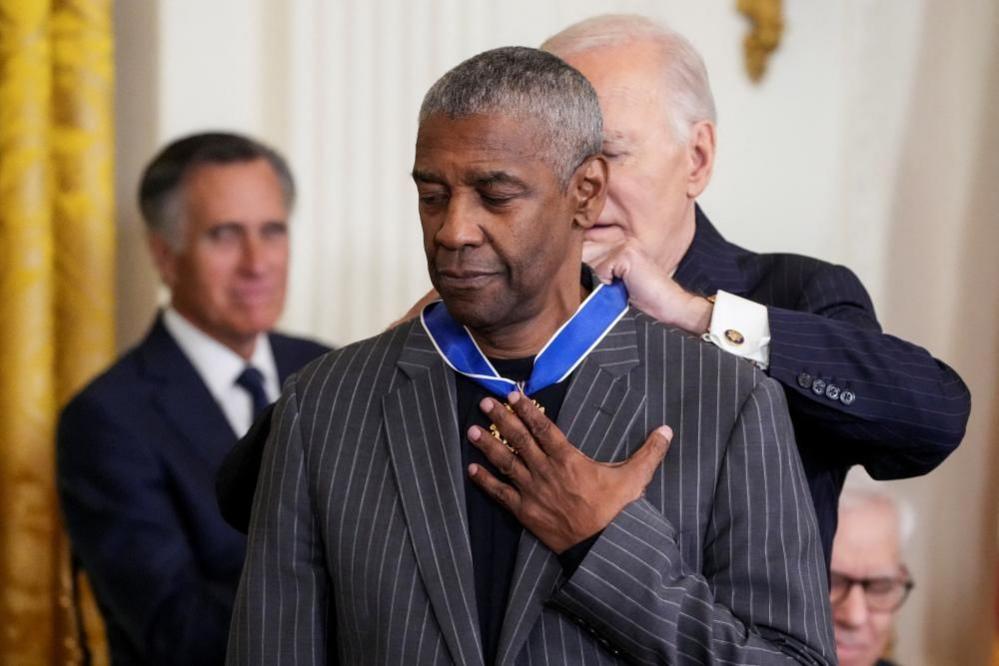 Joe Biden puts medal around Denzel Washington's neck