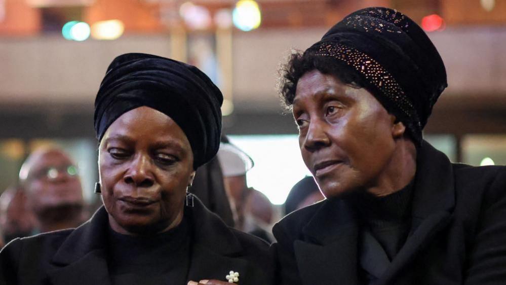 Esther Lungu, the widow of Zambia’s former president Edgar Lungu, is consoled by family memebrs during a service, after the Pretoria High Court halted the planned burial of the former president hours before the ceremony, following a weeks-long feud between Lungu's family and the Zambian government