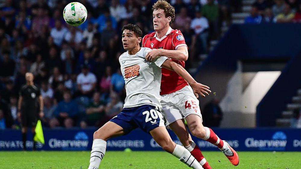 Preston's Theo Carroll shields the ball from Wrexham's Harry Ashfield 