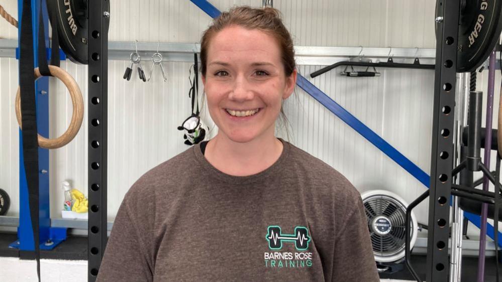 Laura Barnes standing in front of gym equipment in a Stagsden gym