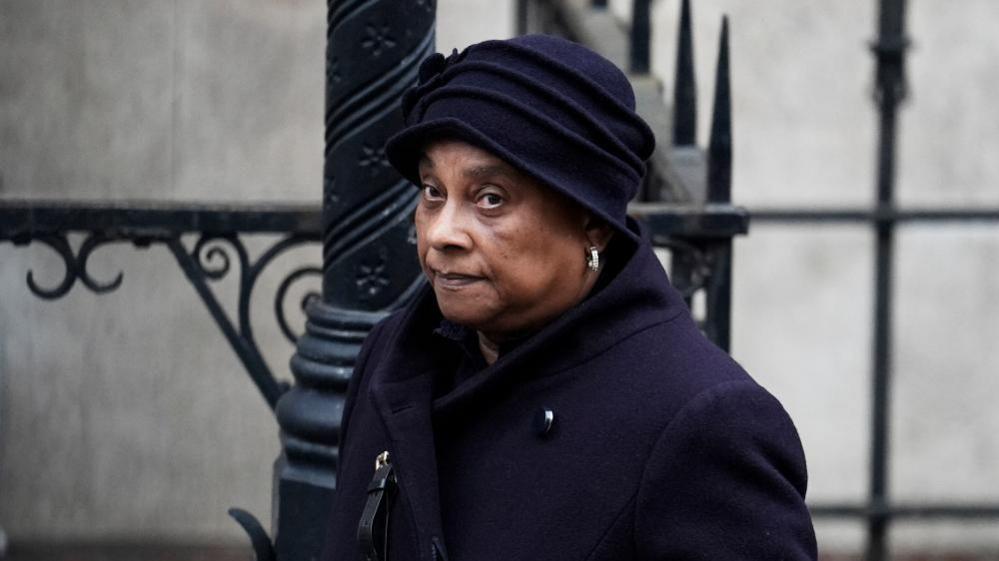 Baroness Lawrence in purple hat and coat