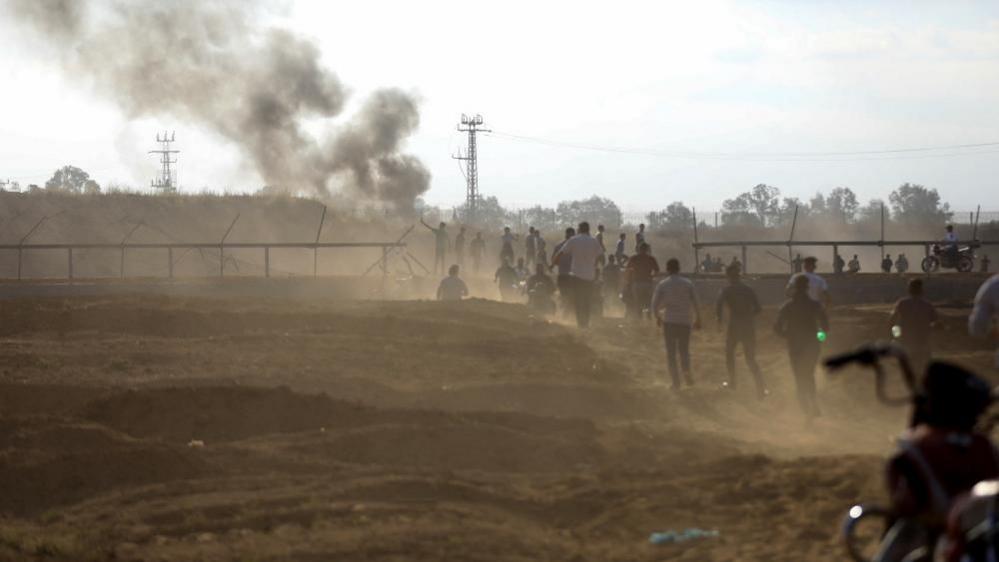 Palestinians run towards breached fence between Gaza and Israel (07/10/24)