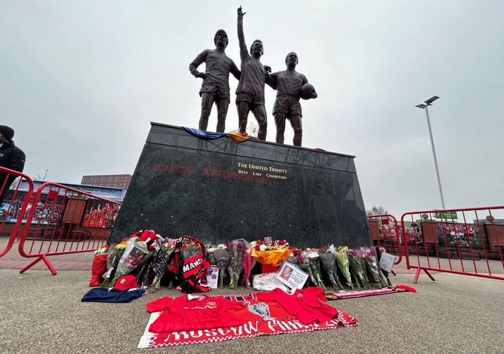 Tributes left for Denis Law by the statue of Manchester United's Holy Trinity outside Old Trafford: George Best, Denis Law, and Bobby Charlton 