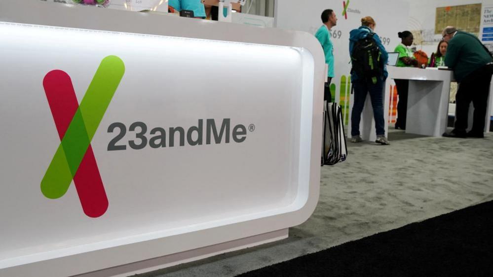 The 23andMe logo at a 2019 genealogy conference where the DNA testing company hosted a booth for attendees