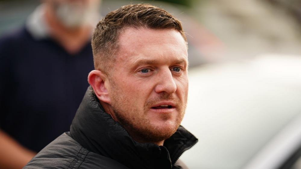 Headshot of Stephen Yaxley-Lennon in a black coat