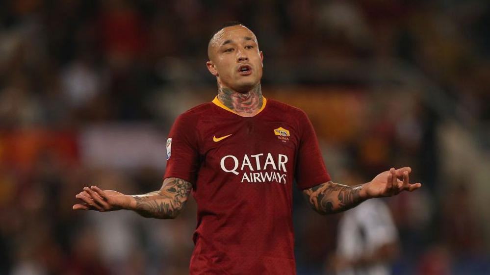 Nainggolan playing for Roma, sticking his arms out in protest