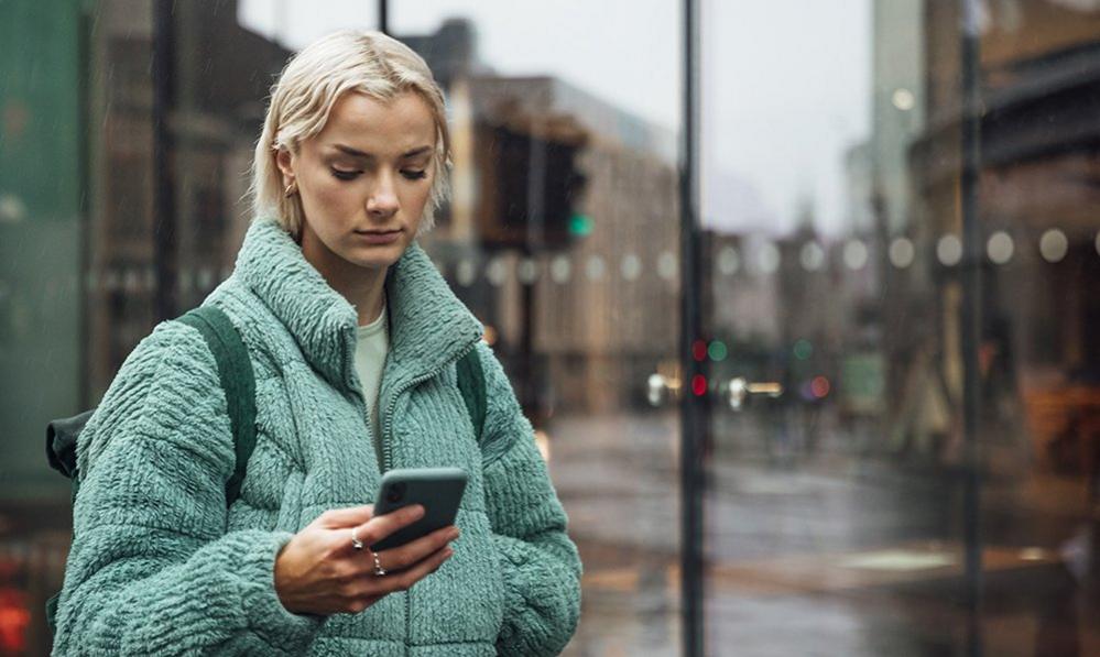 Person using smartphone in street