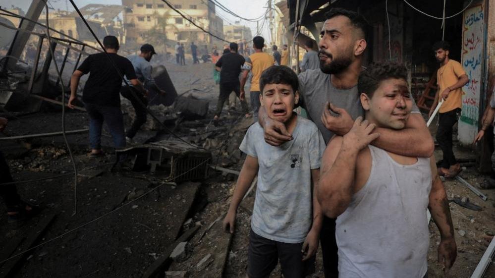 Palestinians react after an air strike in Gaza City (file photo)